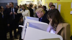 Republican presidential nominee Donald Trump(2nd R) and his wife Melania fill out their ballots at a polling station in a school during the 2016 presidential elections on November 8, 2016 in New York. / AFP PHOTO / MANDEL NGAN